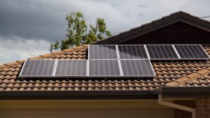 An array of solar panels on a roof of a house